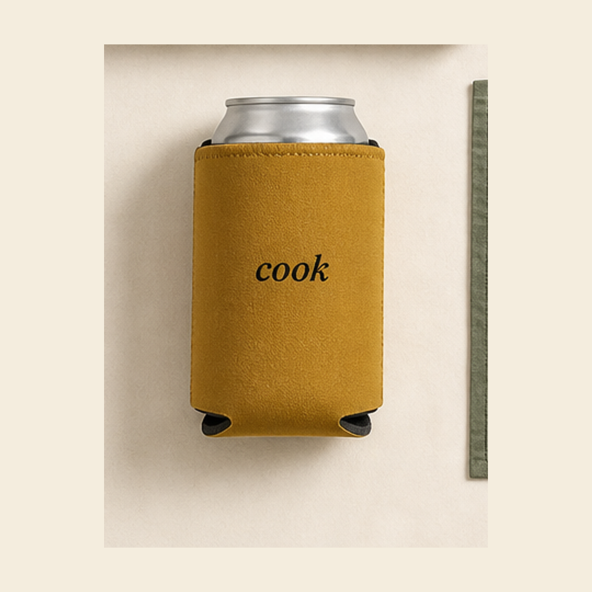 Muted mustard can cooler with black cook wordmark